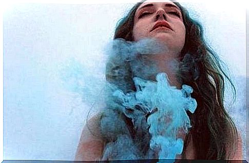 Brunette girl surrounded by blue smoke.