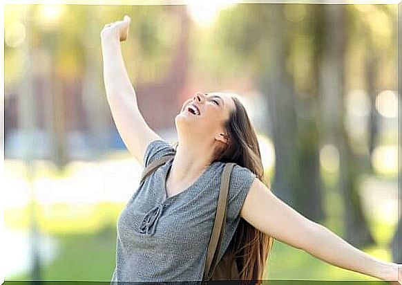 Girl with high self-esteem stretches out her arms in joy