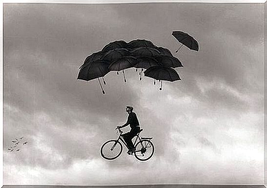 Man rides in the air under umbrellas