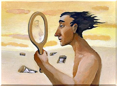 Man looks in a mirror in the desert