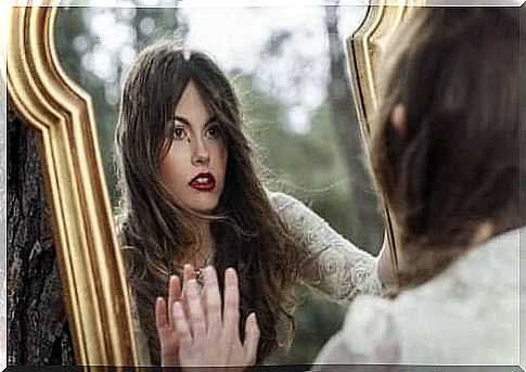 A woman looking at her reflection in a mirror.