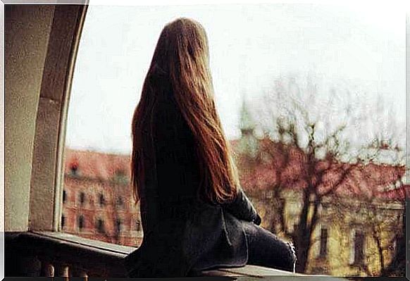 Woman sitting on the balcony confronts her loneliness