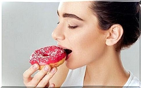 Woman eating donut.