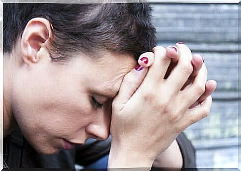 A person holding his head in his hands.