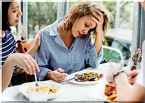 A woman who feels worried about eating.