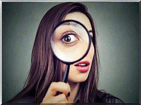 A woman with a magnifying glass.