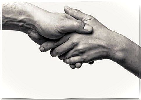 Two people holding hands, representing prosocial behavior.