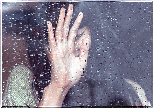 Psychophysiological disorders - woman crying in front of a window