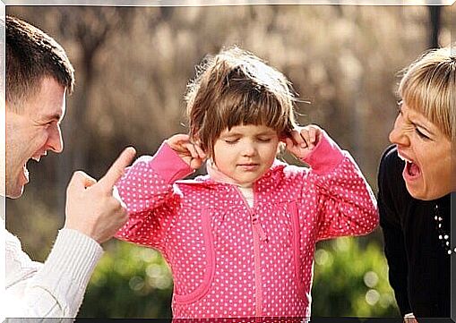 A little girl caught between parents arguing