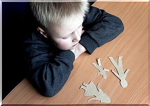 An upset little boy thinking of his parents