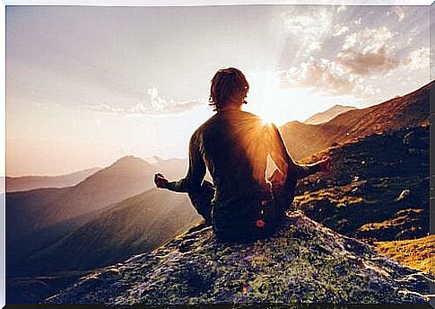 Person meditates on the mountain