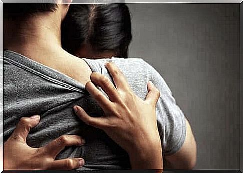 A woman crying in someone's arms