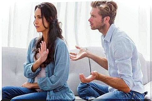 A woman trying to stop a man from talking.