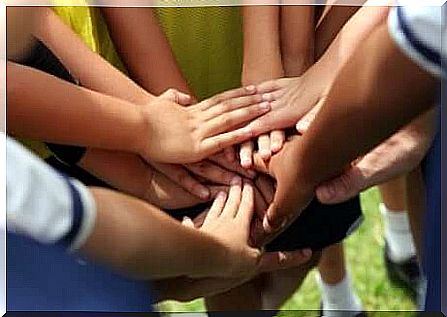 An image of a group of hands touching each other.