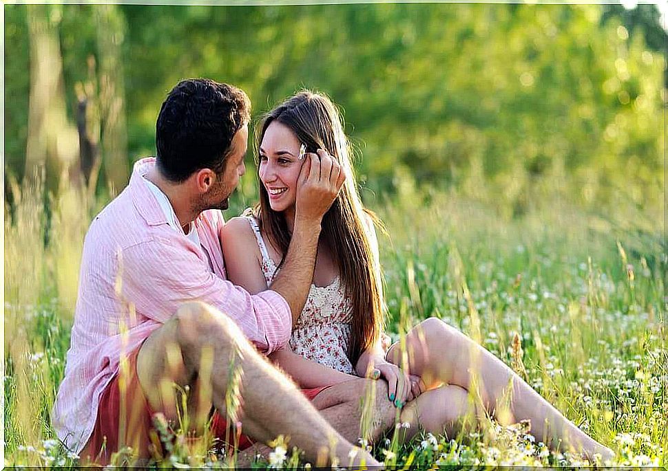 Couple in love sitting in the grass