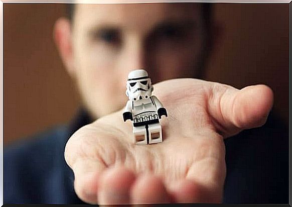 Holding a Lego figure in one hand.