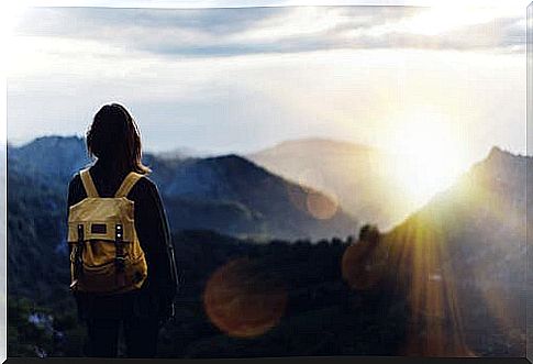 A woman looking out over a mountain.