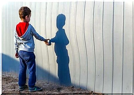 A boy playing with his shadow.