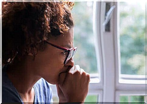 Worried woman by window