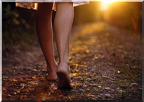 Barefoot woman on a path.