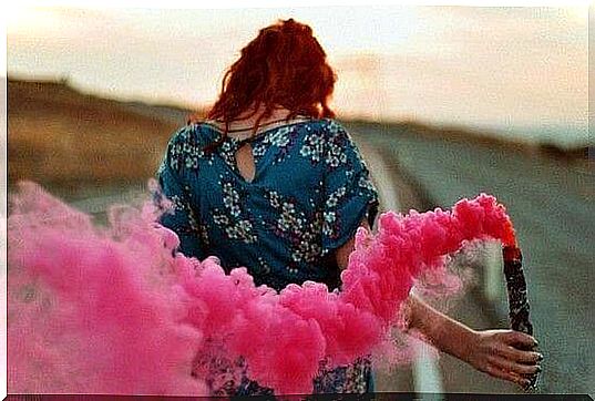 Woman with pink smoke